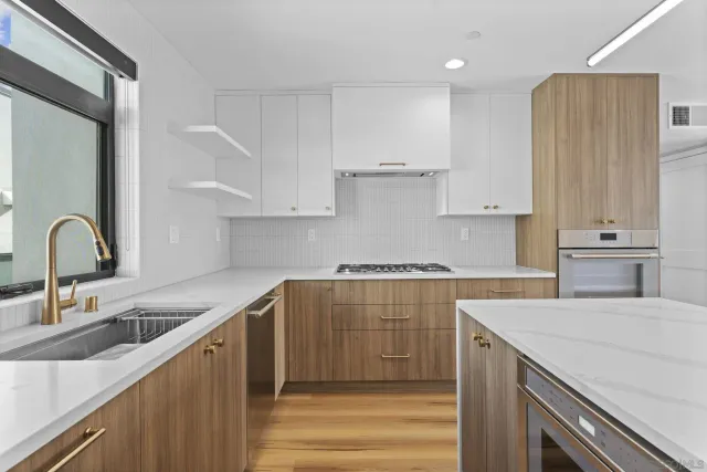 a kitchen with a sink cabinets and appliances