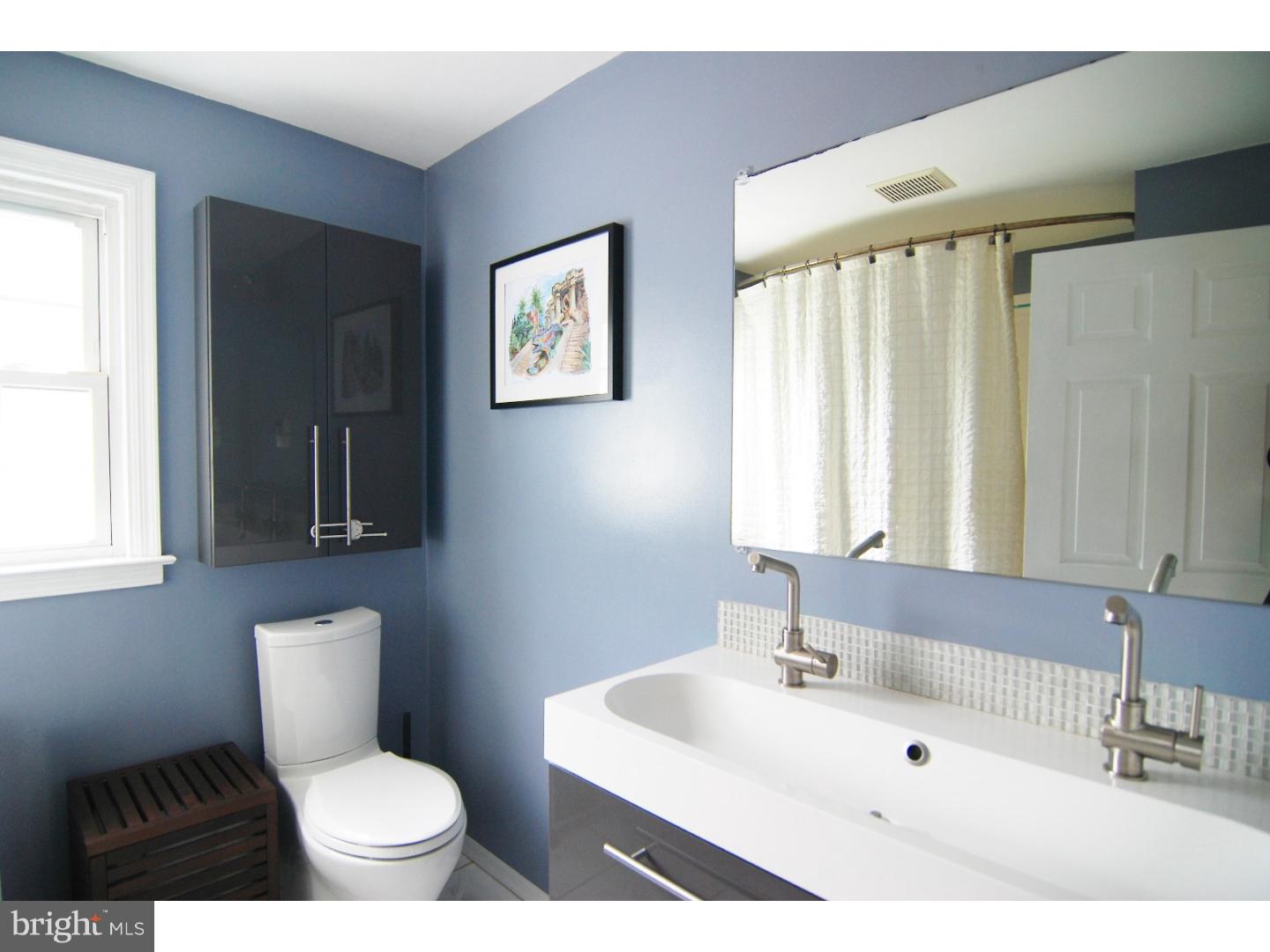 18 Shirley Road Hatboro, PA 19040 - Photo 13 of 24 a bathroom with a sink a toilet a mirror and window