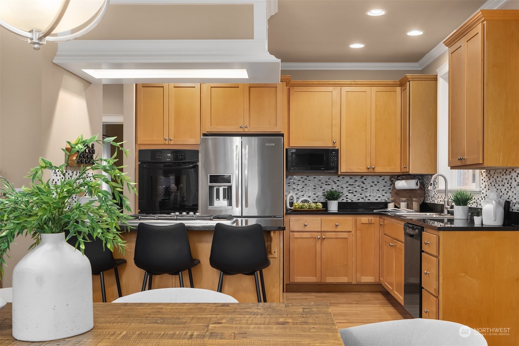2202 19th Street Anacortes, WA 98221 - Photo 15 of 33 a kitchen with stainless steel appliances granite countertop a refrigerator a stove a sink dishwasher and white cabinets with wooden floor