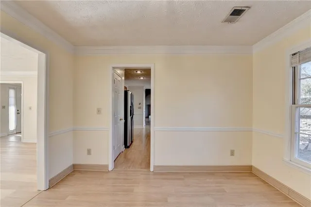 a kitchen with stainless steel appliances granite countertop white cabinets granite counter tops and a window
