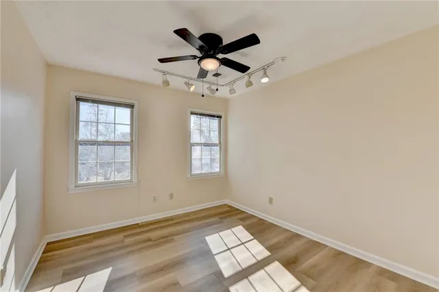 a spacious bathroom with a double vanity sink a mirror and a bathtub