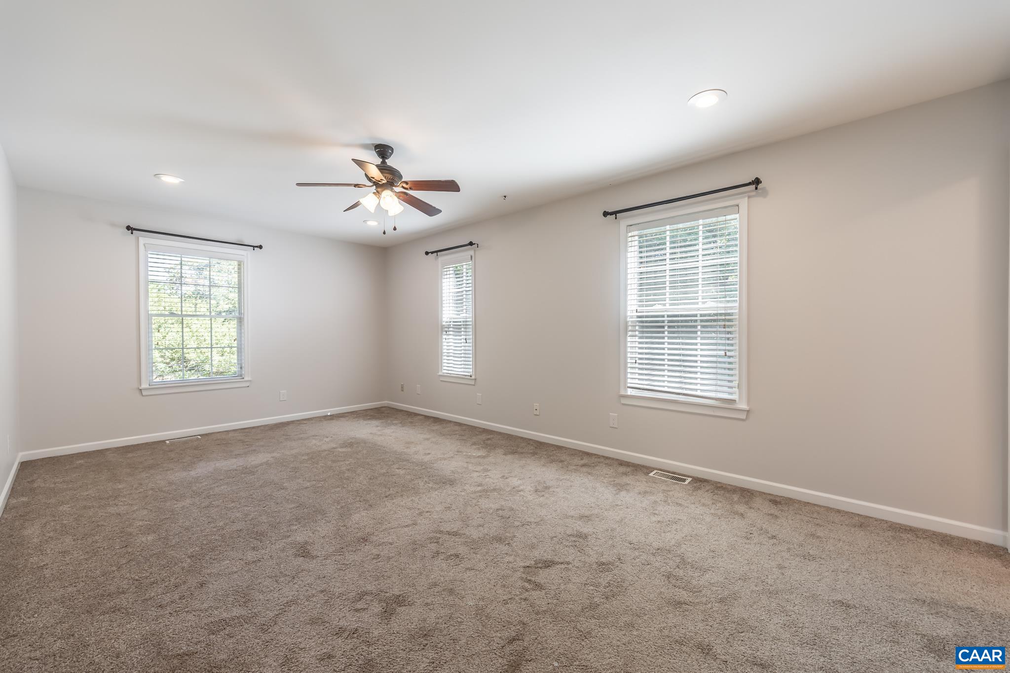 124 Fox Ridge Lane Ruckersville, VA 22968 - Photo 18 of 52 an empty room with windows and chandelier fan