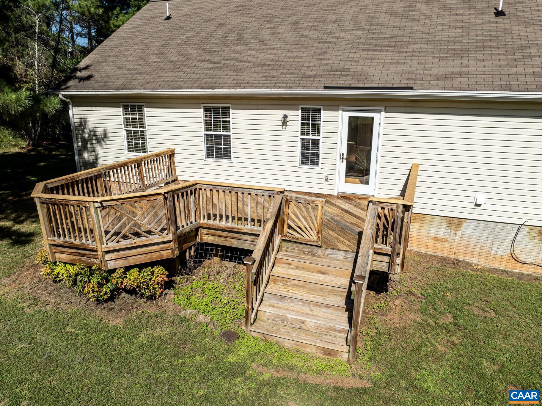 124 Fox Ridge Lane Ruckersville, VA 22968 - Photo 38 of 52 a roof deck with a chair and wooden floor