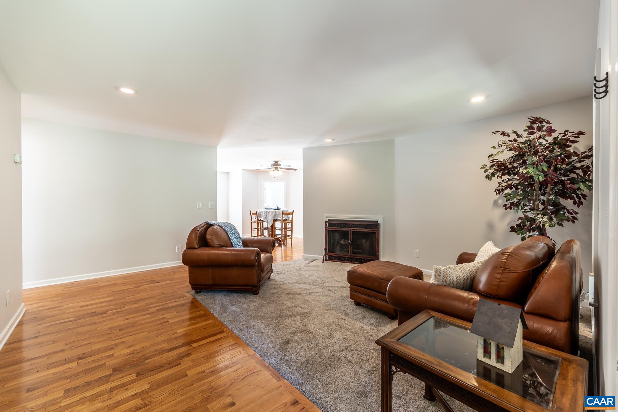 124 Fox Ridge Lane Ruckersville, VA 22968 - Photo 8 of 52 a living room with furniture a fireplace and a potted plant