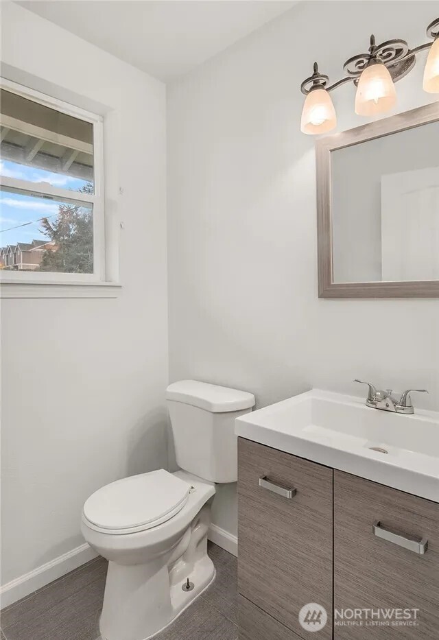 4050 South Puget Sound Avenue Tacoma, WA 98409 - Photo 11 of 19 a bathroom with a toilet sink and mirror