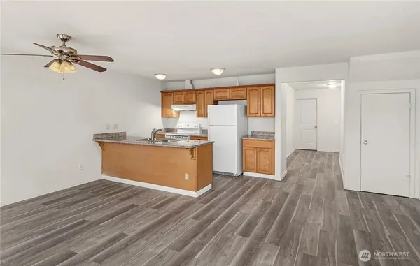 a view of a kitchen with wooden floor and a sink