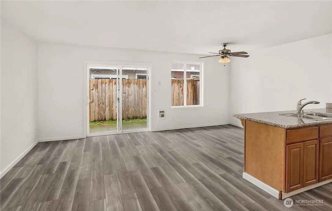 4050 South Puget Sound Avenue Tacoma, WA 98409 - Photo 4 of 19 a view of an empty room with a window and wooden floor