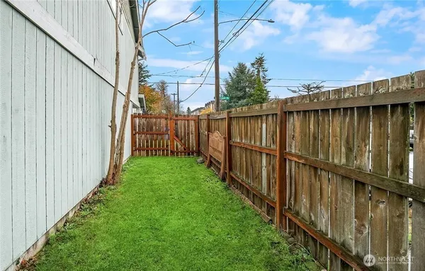 a view of a pathway of a wooden fence