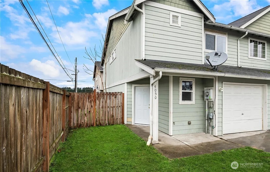 4050 South Puget Sound Avenue Tacoma, WA 98409 - Photo 10 of 19 a front view of a house with a garden