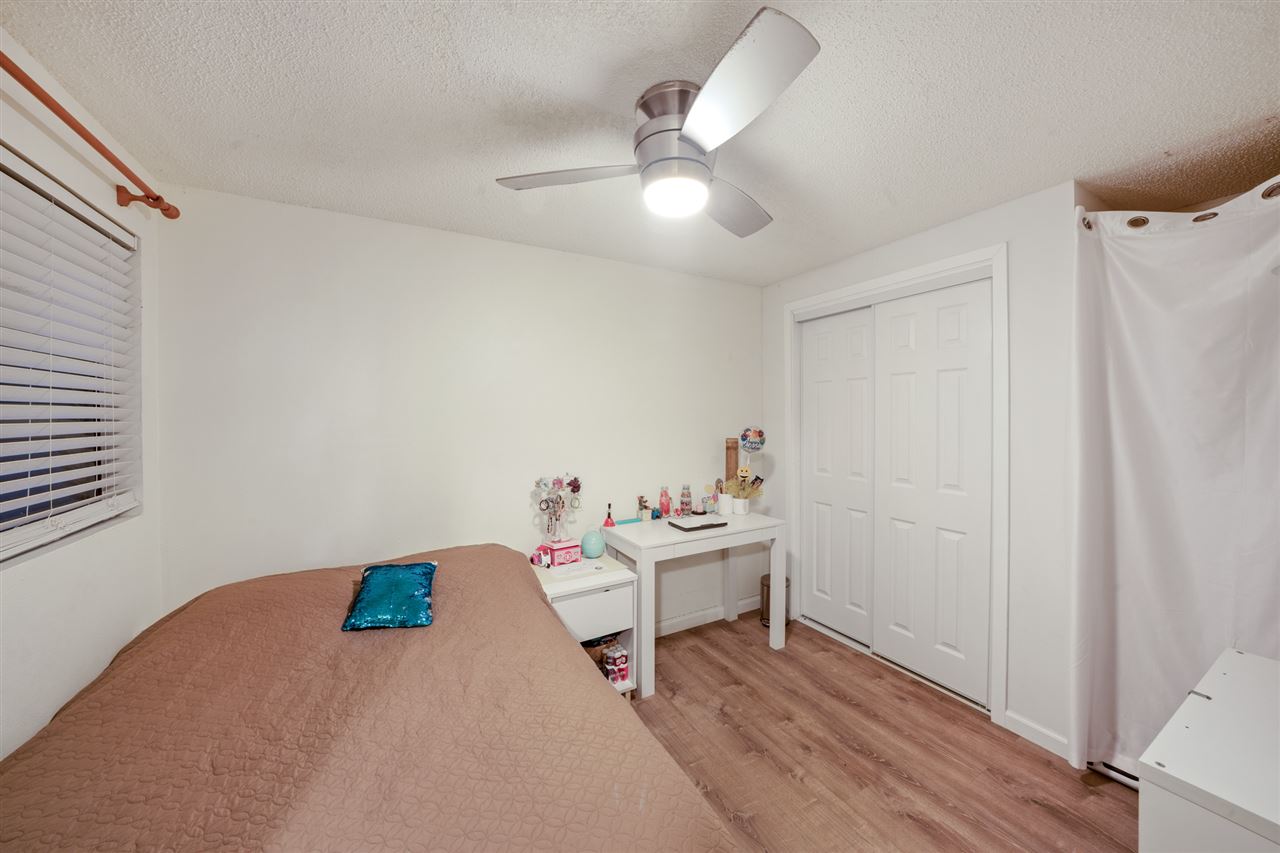 2747 South Kihei Road, Unit C005 Kihei, HI 96753 - Photo 17 of 29 a bedroom with a bed and a chandelier fan