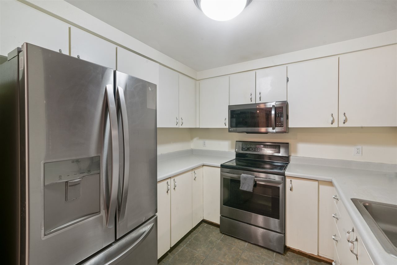 2747 South Kihei Road, Unit C005 Kihei, HI 96753 - Photo 3 of 29 a kitchen with stainless steel appliances and white cabinets