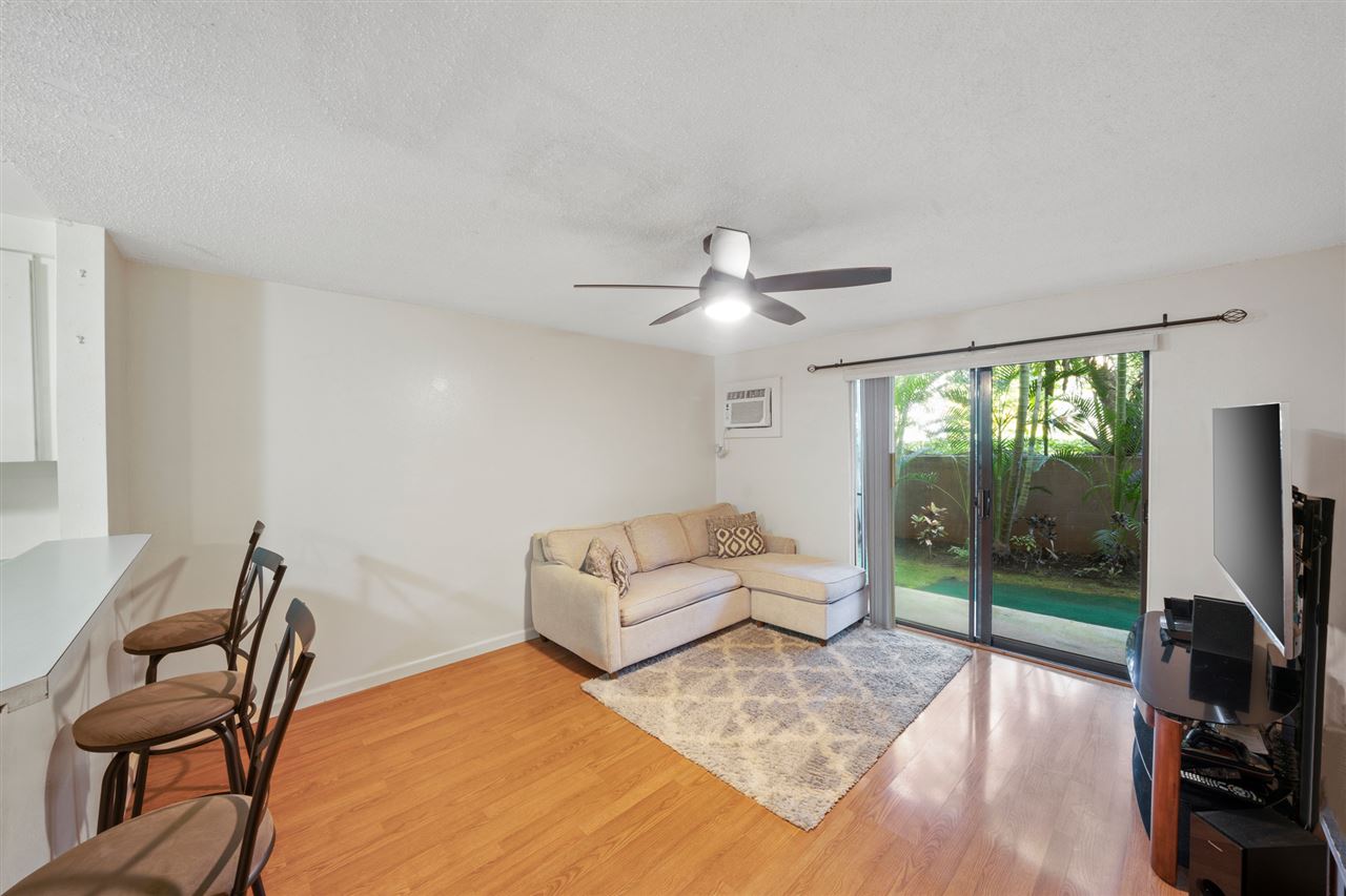 2747 South Kihei Road, Unit C005 Kihei, HI 96753 - Photo 4 of 29 a living room with furniture a ceiling fan and a flat screen tv