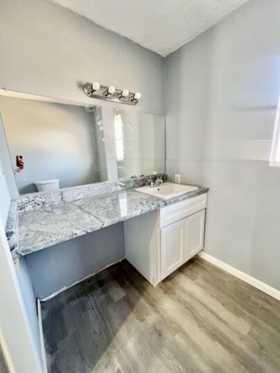 2802 40th Street Lubbock, TX 79413 - Photo 5 of 11 a spacious bathroom with a granite countertop sink and a mirror