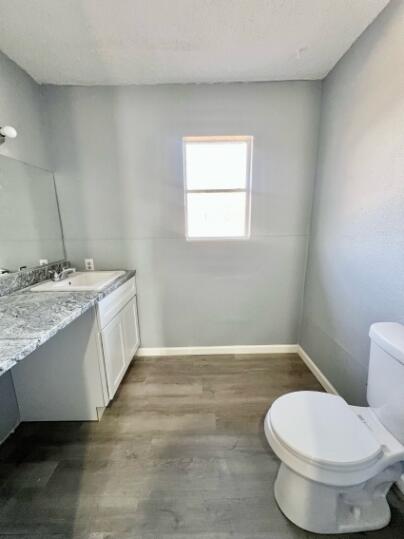 2802 40th Street Lubbock, TX 79413 - Photo 6 of 11 a bathroom with a granite countertop toilet and a sink
