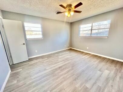 2802 40th Street Lubbock, TX 79413 - Photo 9 of 11 a view of an empty room with a window and wooden floor