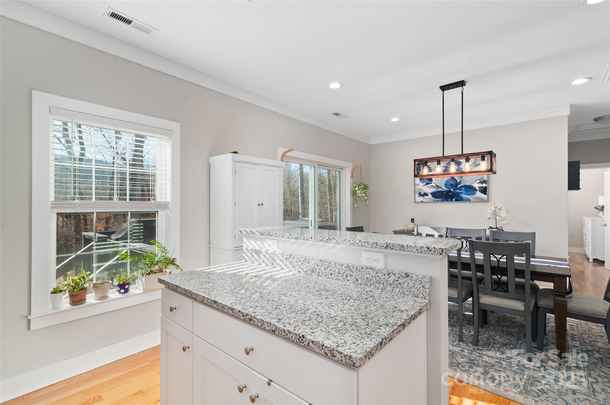 349 Ridge View Drive Clyde, NC 28721 - Photo 12 of 27 a view of a kitchen with granite countertop kitchen island stainless steel appliances a table and chairs in it
