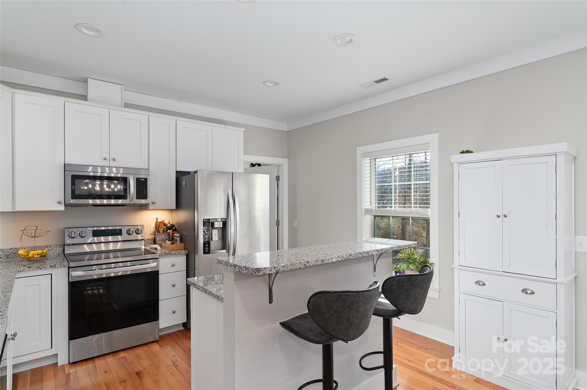 349 Ridge View Drive Clyde, NC 28721 - Photo 13 of 27 a kitchen with granite countertop a stove and a refrigerator