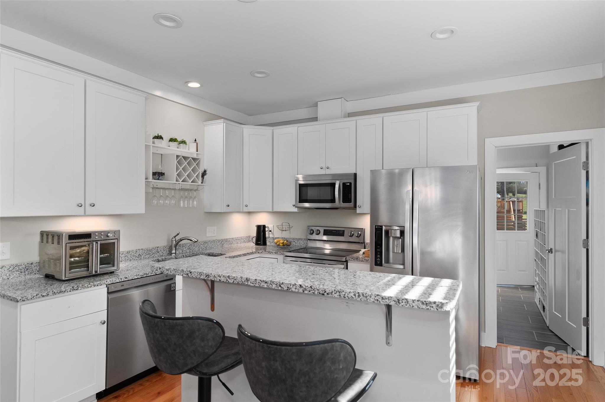 349 Ridge View Drive Clyde, NC 28721 - Photo 15 of 27 a kitchen with stainless steel appliances granite countertop a sink refrigerator and microwave
