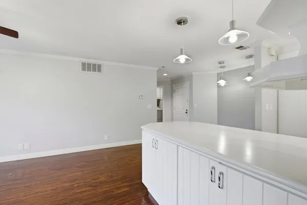 a view of a kitchen with a sink and chandelier