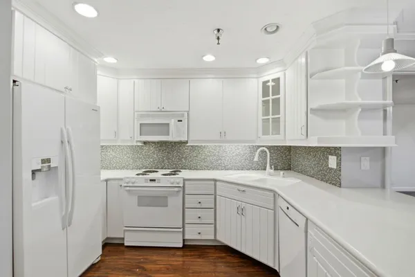 a kitchen with a white cabinets stove and refrigerator