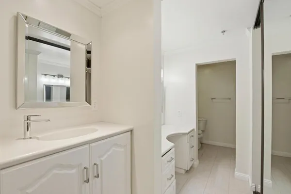 a bathroom with a sink toilet and mirror