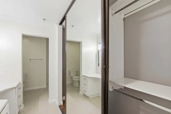 a view of a bathroom with a glass door and a toilet