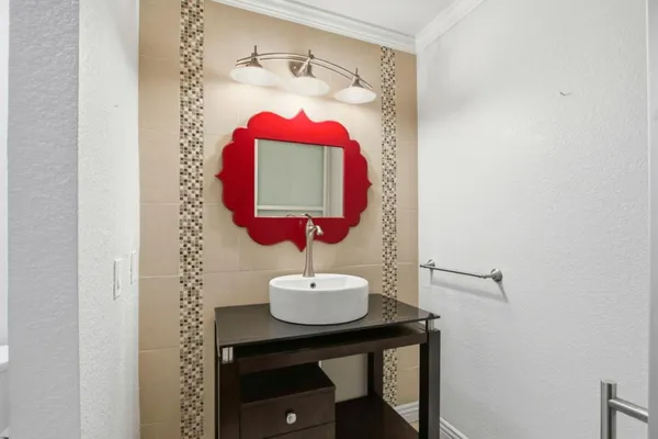 a view of a bathroom with a sink and a mirror