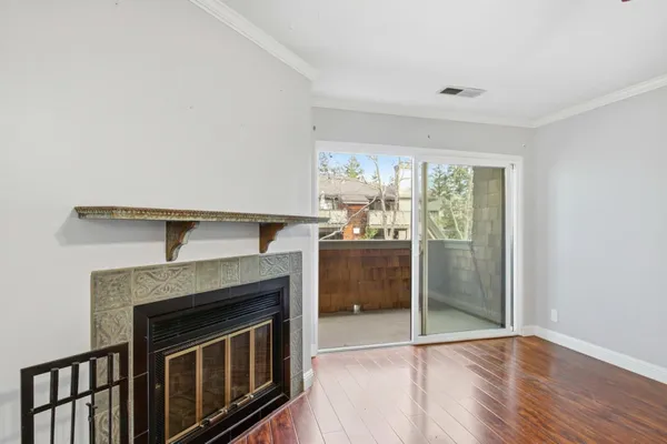 a hallway with a fireplace and a cabinet