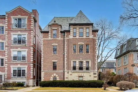 a front view of a residential apartment building with a yard