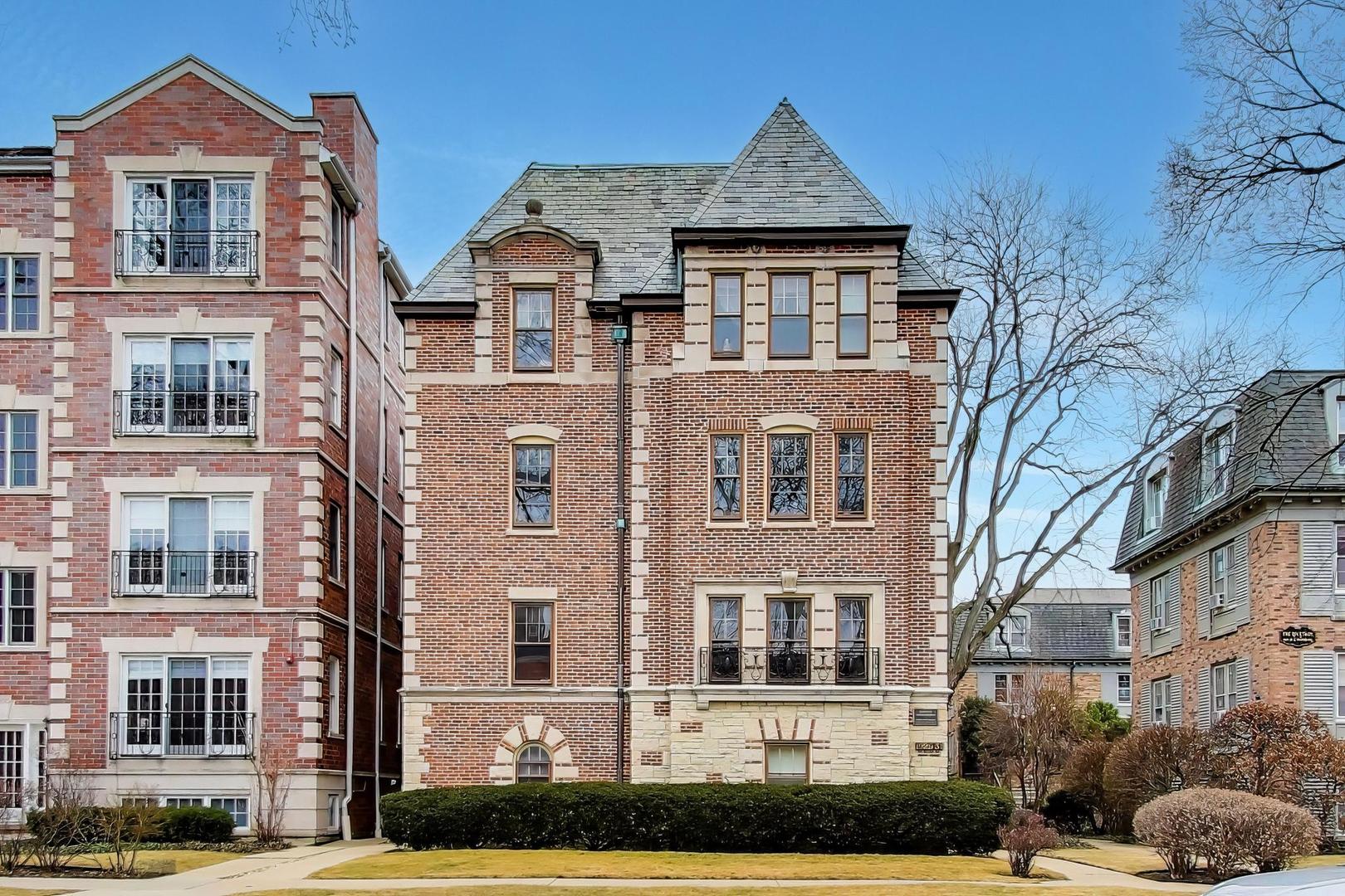 a front view of a residential apartment building with a yard