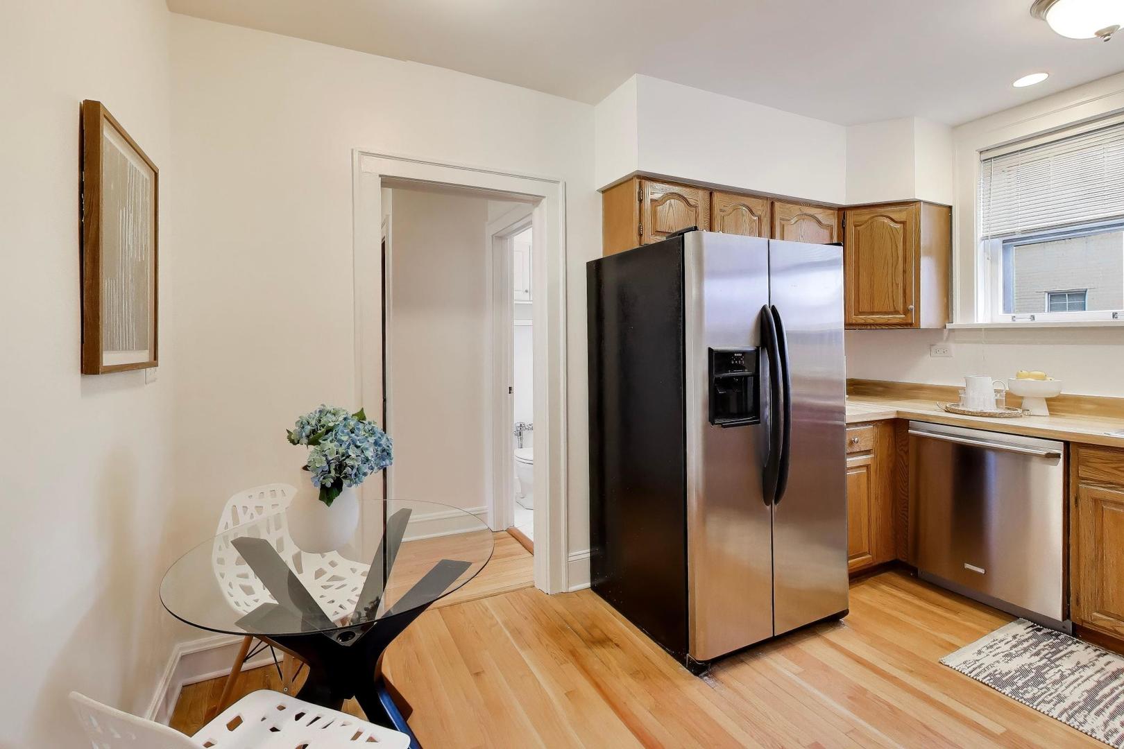 1929 Sherman Avenue, Unit 2W Evanston, IL 60201 - Photo 11 of 26 a kitchen with stainless steel appliances a refrigerator and a stove