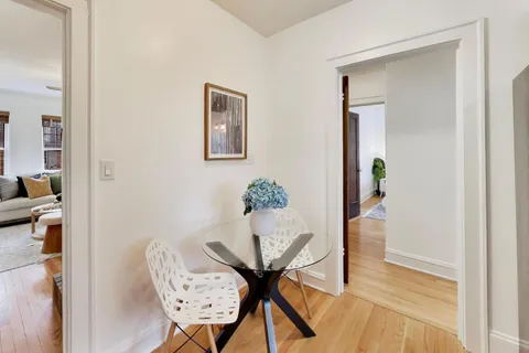 a bedroom with a bed a window and potted plant