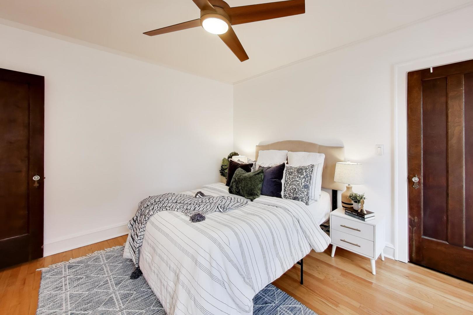1929 Sherman Avenue, Unit 2W Evanston, IL 60201 - Photo 14 of 26 a bedroom with a bed and wooden floor