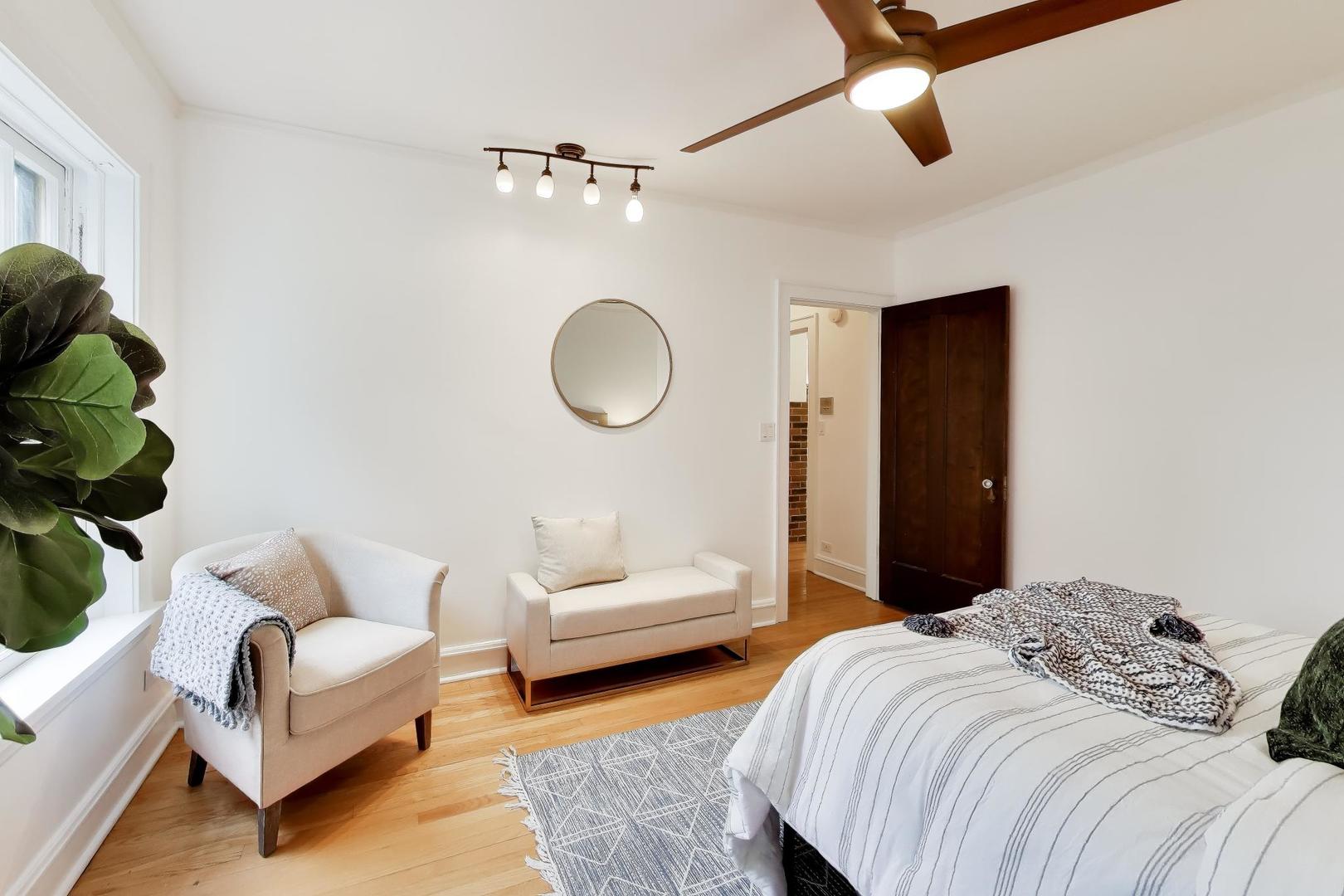 1929 Sherman Avenue, Unit 2W Evanston, IL 60201 - Photo 15 of 26 a bedroom with bed and a couch