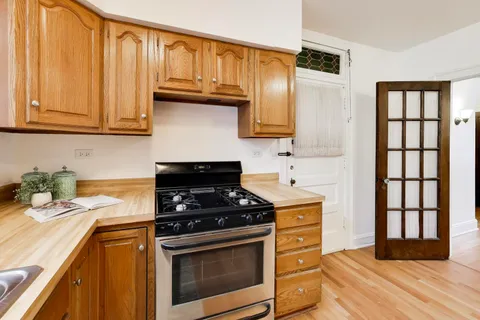 a kitchen with a refrigerator and cabinets