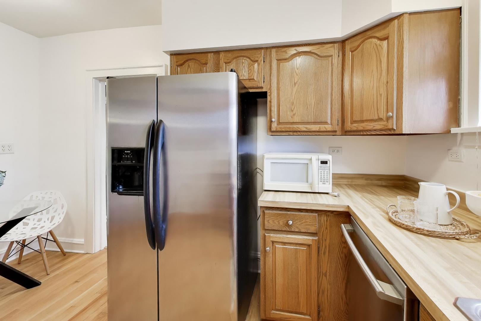 1929 Sherman Avenue, Unit 2W Evanston, IL 60201 - Photo 9 of 26 a kitchen with a refrigerator and cabinets