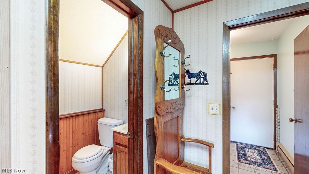 38667 Chestnut Ridge Road Elyria, OH 44035 - Photo 22 of 35 Powder room with wood-finish wainscoting and a corner vanity
