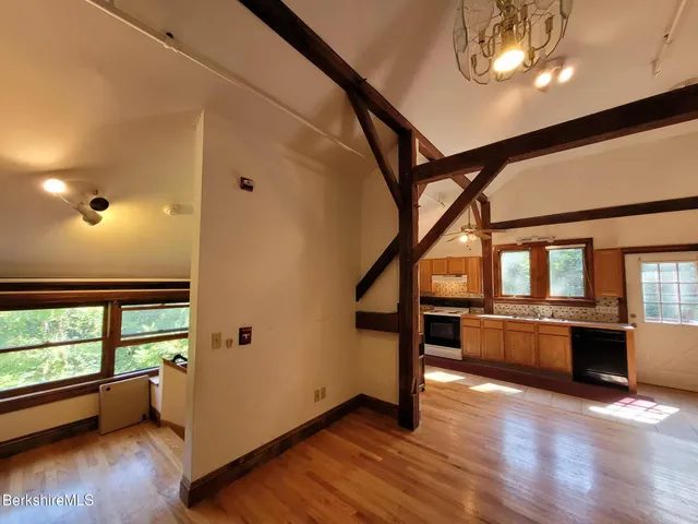 a view of dining room with wooden floor and furniture