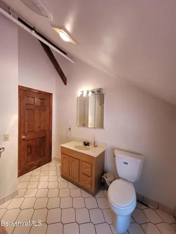 a bathroom with a sink toilet and mirror
