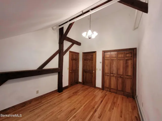 a view of a livingroom with wooden floor and stairs