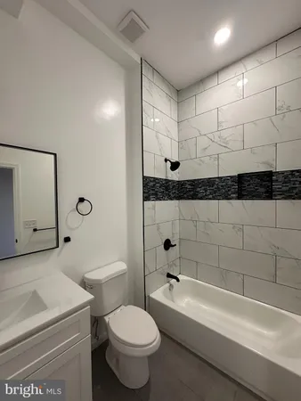 a bathroom with a toilet a sink and bathtub