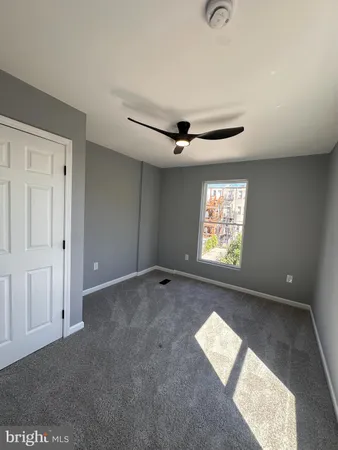 a view of an empty room and a window