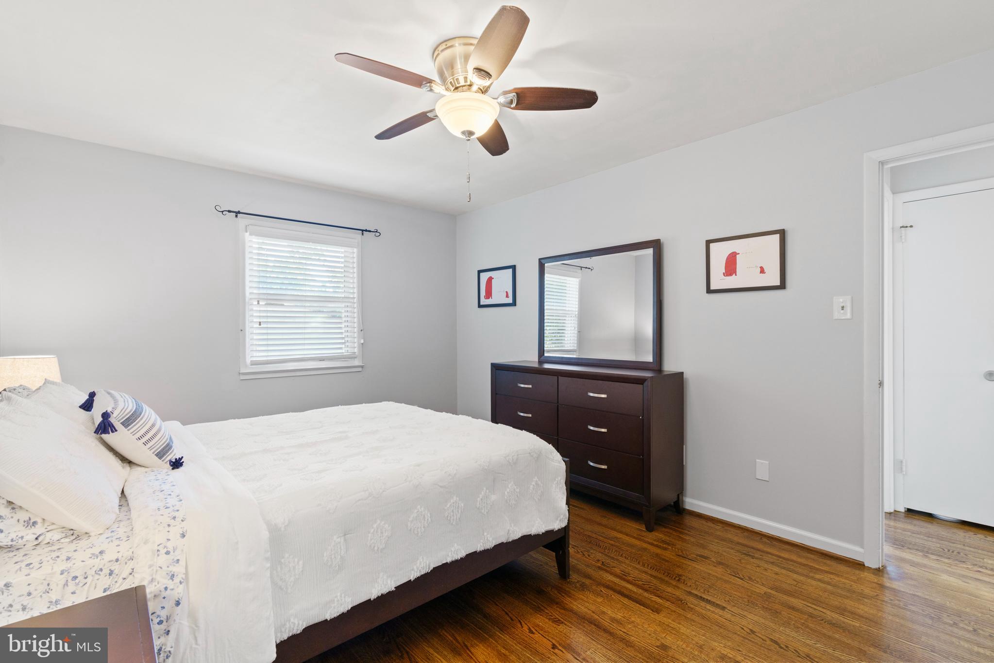 8608 Langport Drive Springfield, VA 22152 - Photo 23 of 43 a bedroom with a bed and wooden floor