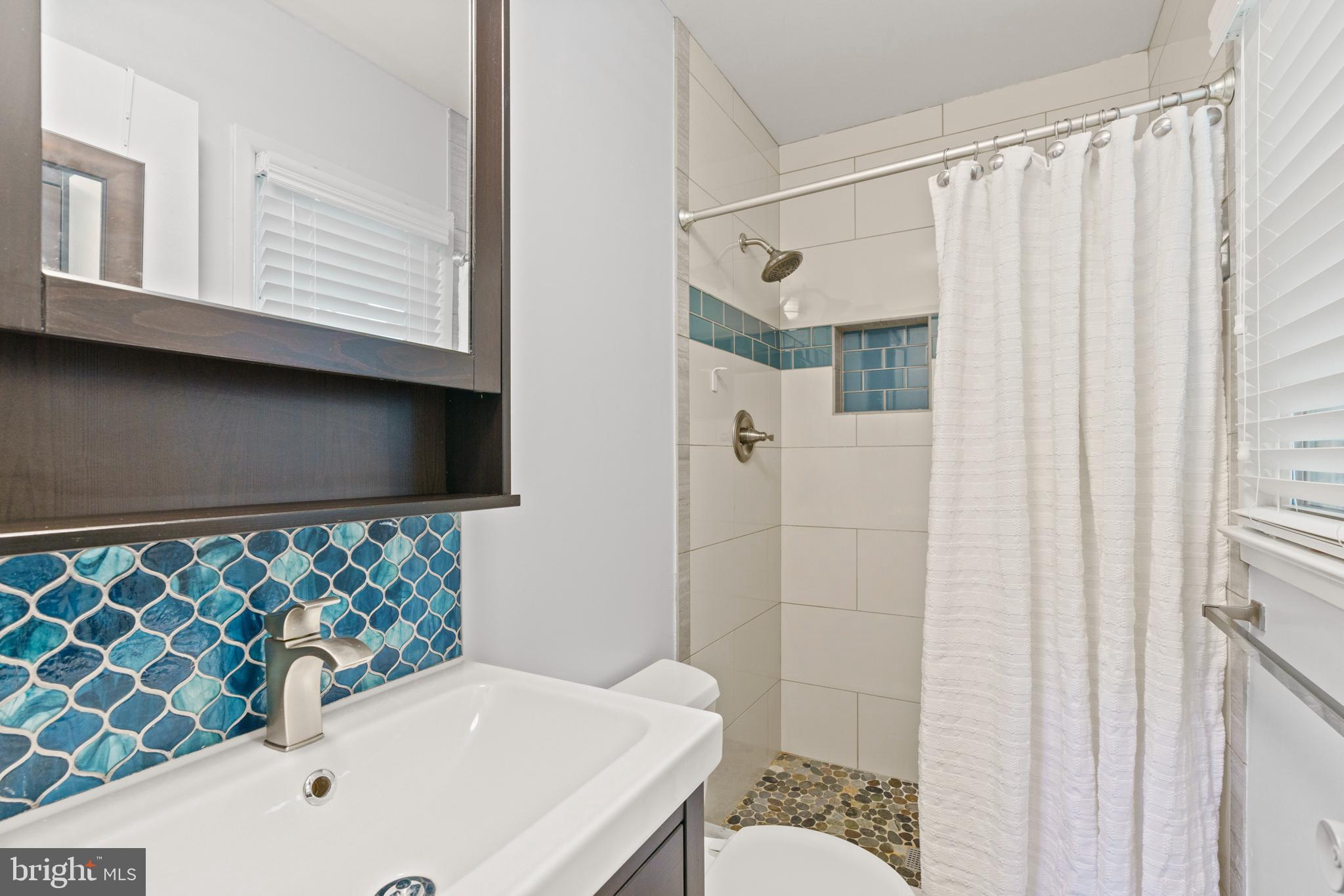 8608 Langport Drive Springfield, VA 22152 - Photo 24 of 43 a bathroom with a sink and a mirror
