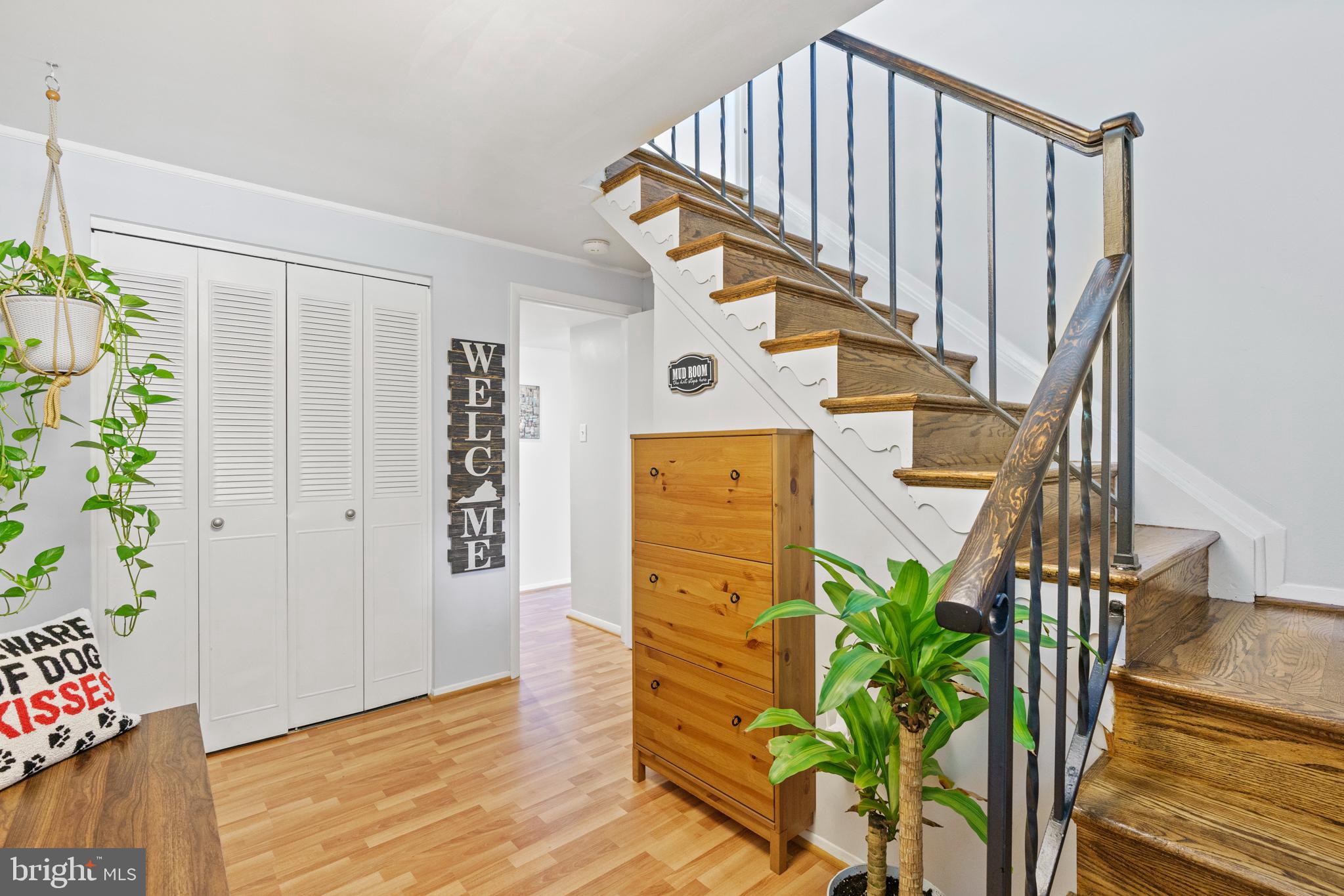 8608 Langport Drive Springfield, VA 22152 - Photo 25 of 43 a view of staircase with wooden floor and a potted plant