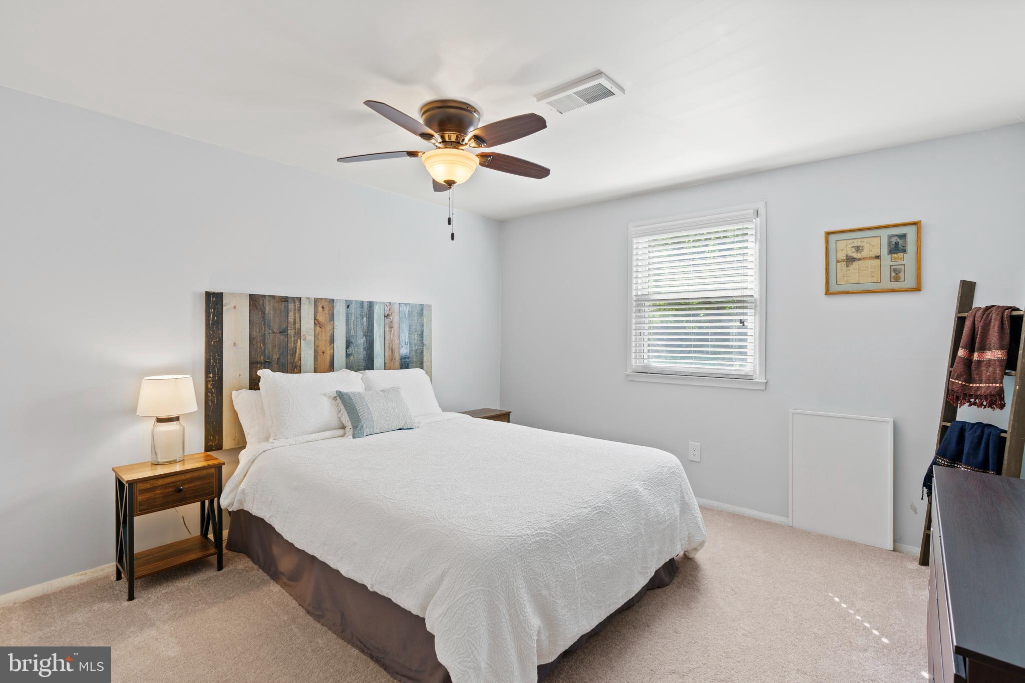 8608 Langport Drive Springfield, VA 22152 - Photo 30 of 43 a bedroom with a bed and a chandelier