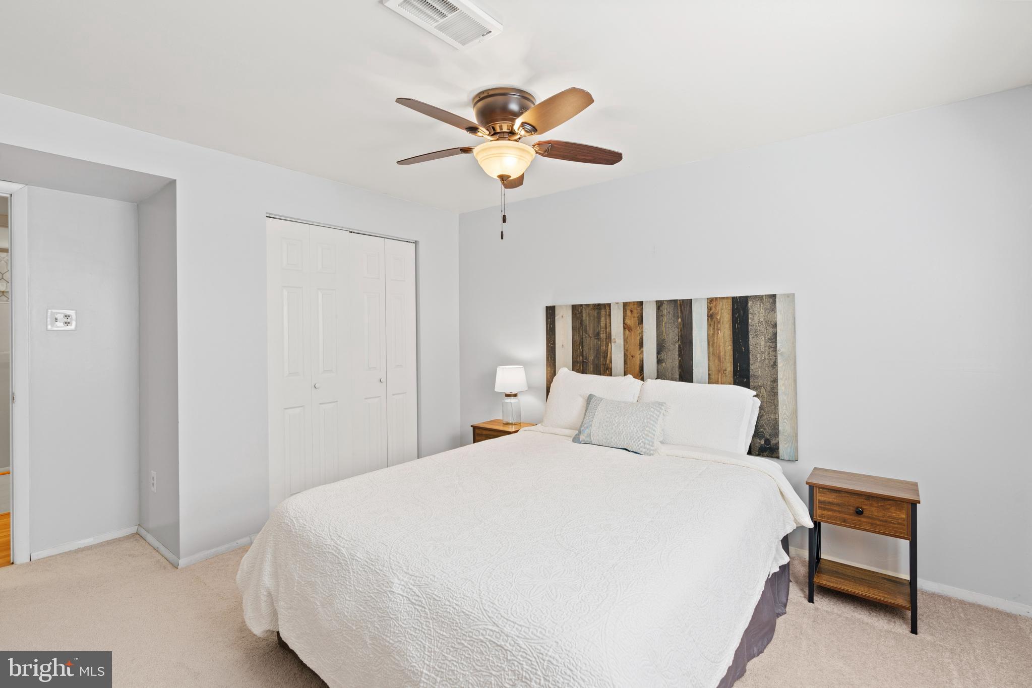 8608 Langport Drive Springfield, VA 22152 - Photo 32 of 43 a bedroom with a bed and a ceiling fan