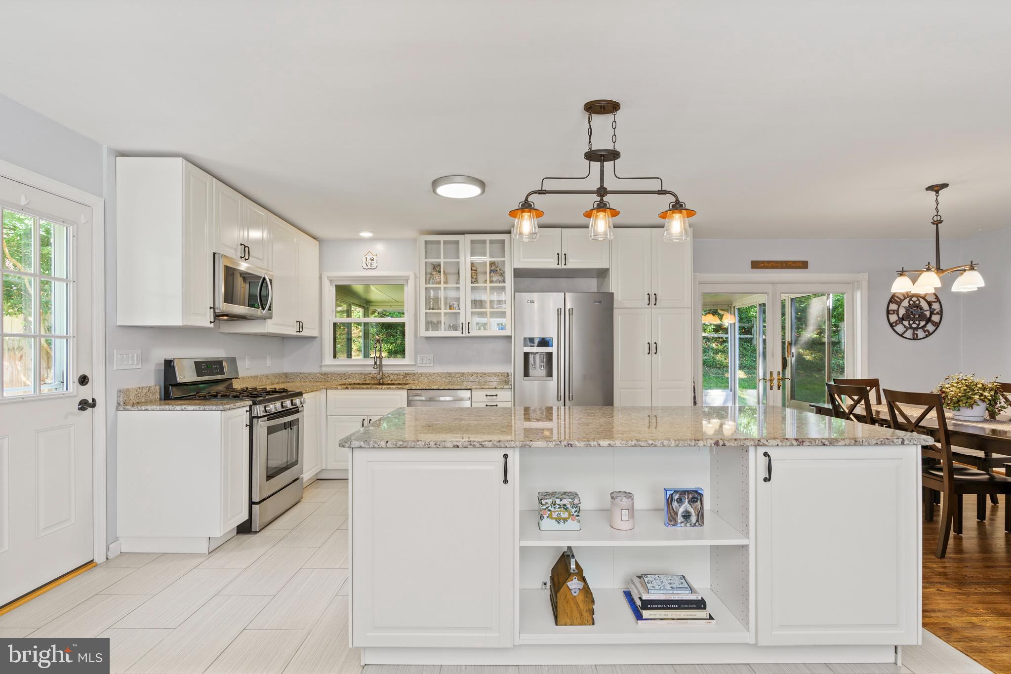 8608 Langport Drive Springfield, VA 22152 - Photo 5 of 43 a kitchen with kitchen island white cabinets and refrigerator