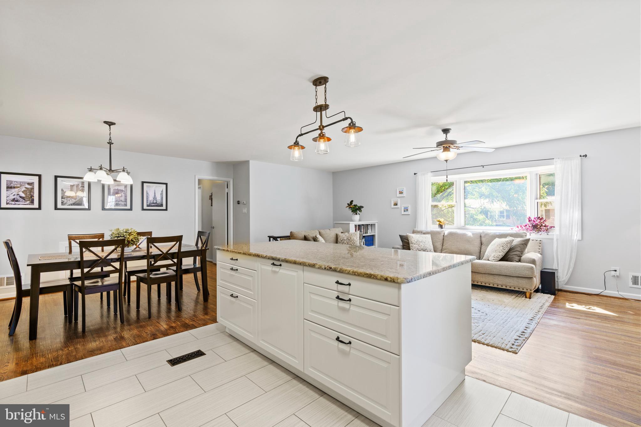 8608 Langport Drive Springfield, VA 22152 - Photo 7 of 43 a kitchen with kitchen island a stove a table and chairs in it
