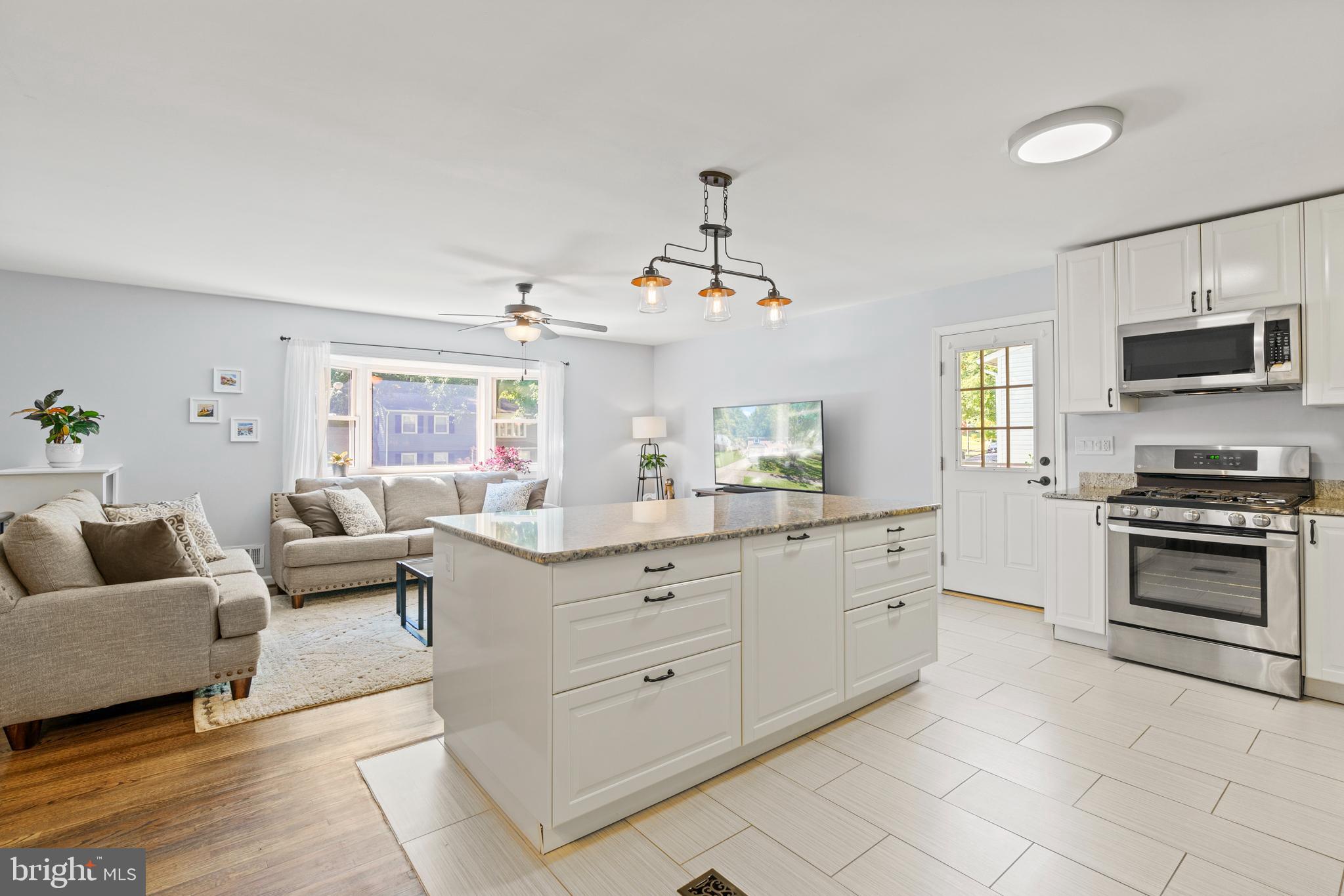8608 Langport Drive Springfield, VA 22152 - Photo 8 of 43 a living room with furniture and a flat screen tv
